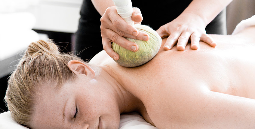 Massage med urtebolde som blødgør huden og beroliger sjælen